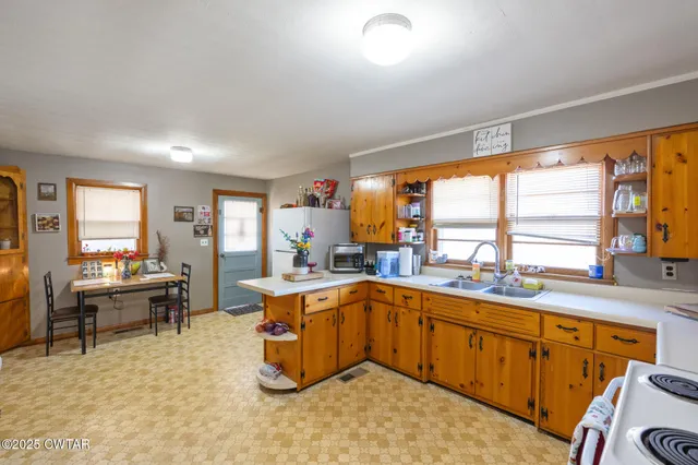 a kitchen with a sink stove and cabinets