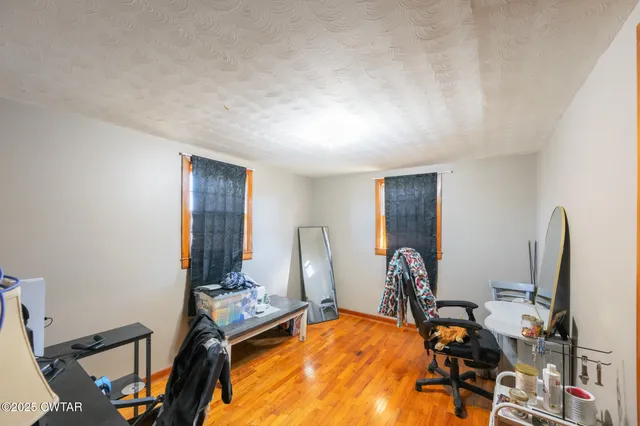 a room with gym equipment and large mirror