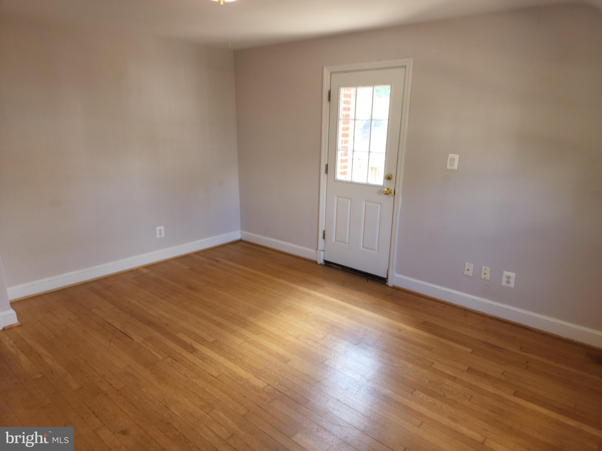 1227 North Utah Street, Unit 3 Arlington, VA 22201 - Photo 16 of 26 an empty room with wooden floor and windows