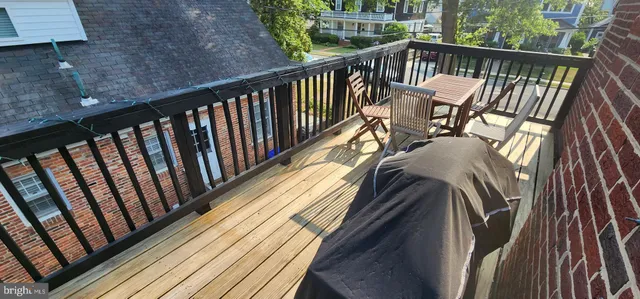a view of a balcony with wooden floor