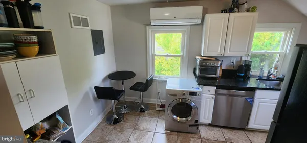 a kitchen with a sink a window and cabinets