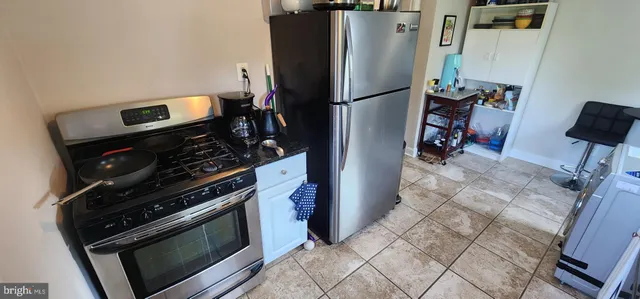 a kitchen with a stove and a refrigerator