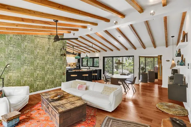 a living room with patio furniture and a floor to ceiling window