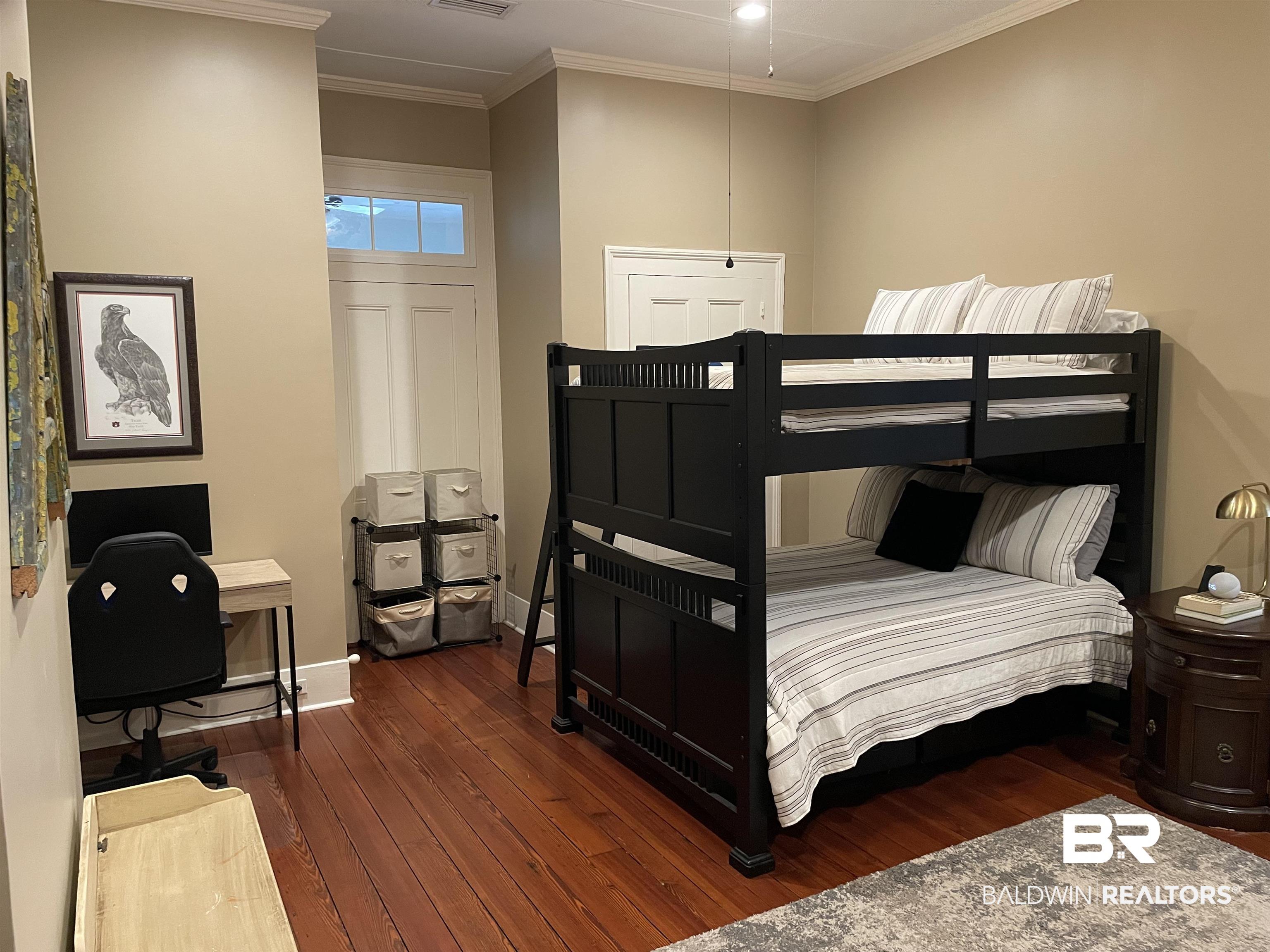 1001 Augusta Street Mobile, AL 36604 - Photo 8 of 26 Bedroom with crown molding and dark hardwood / wood-style flooring