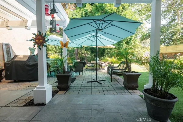 a view of a patio with plants and chairs