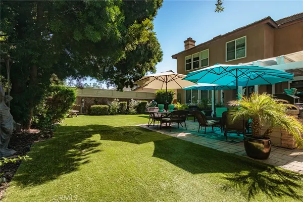 a view of a house with backyard sitting area and garden