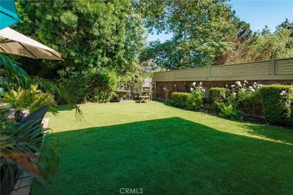 a view of yard with grass and trees