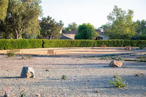 a view of a yard with wooden fence