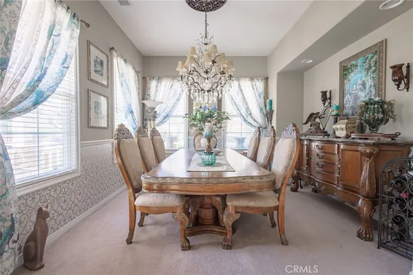 a view of a dining room with furniture and window