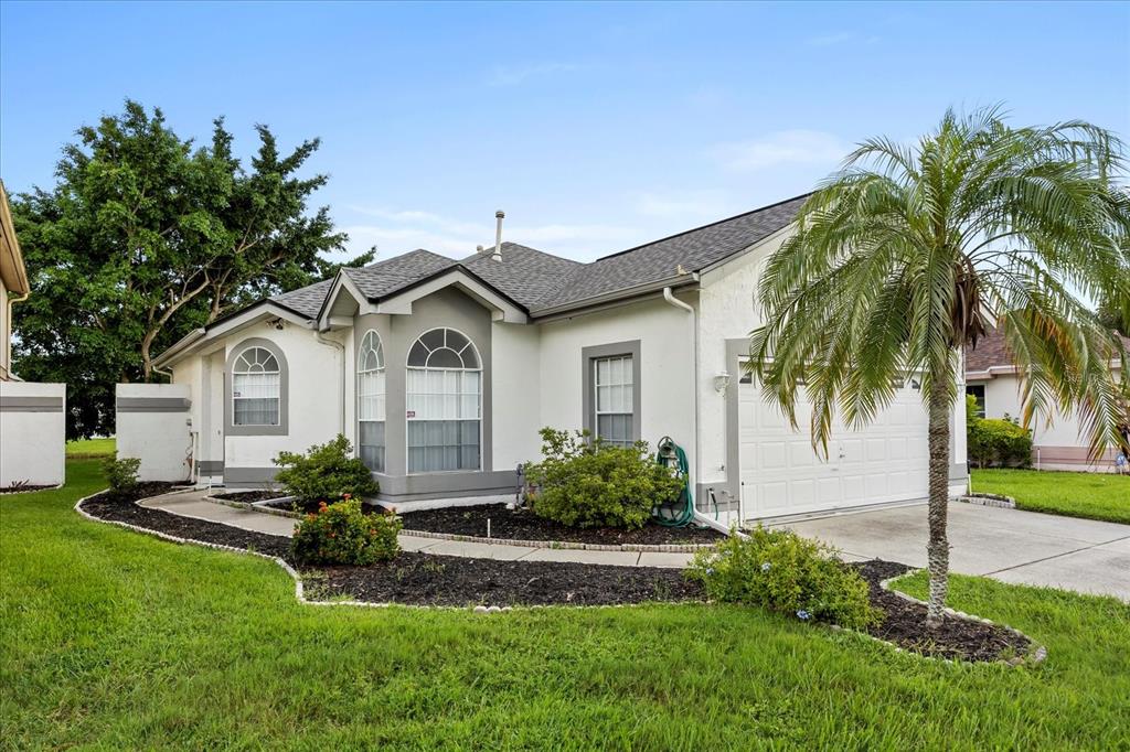 a front view of a house with a garden
