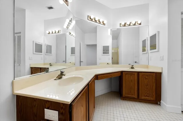 a bathroom with a sink double vanity and a mirror