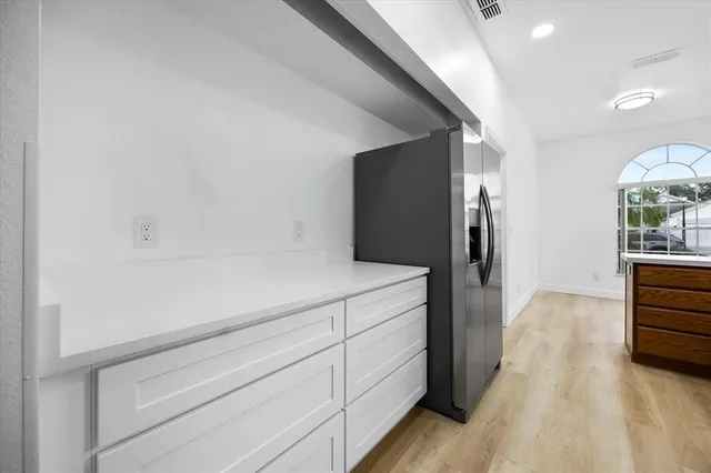 a view of hallway with wooden floor