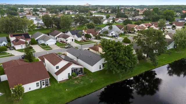 an aerial view of residential house with outdoor space and lake view