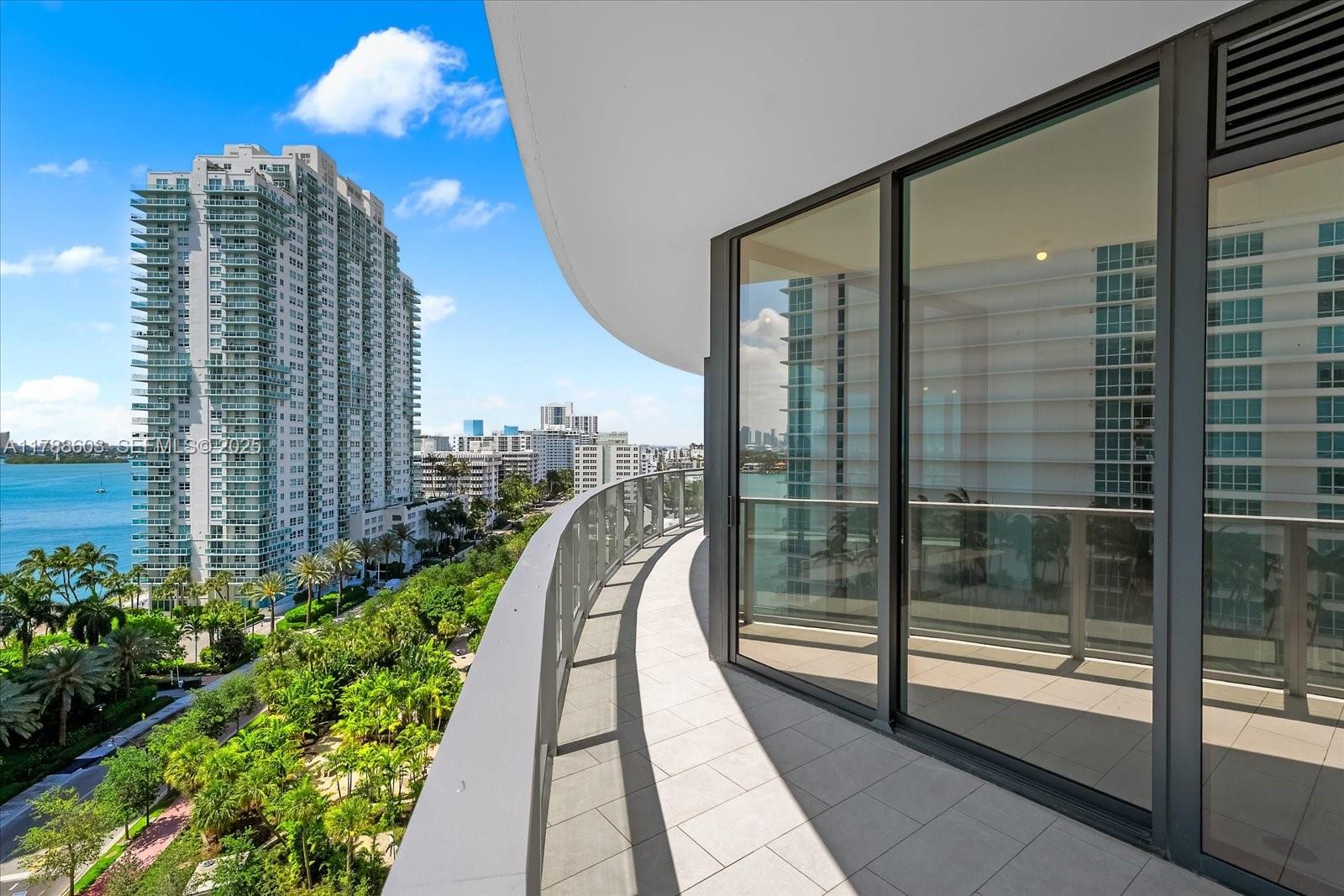 500 Alton Road, Unit 1105 Miami Beach, FL 33139 - Photo 13 of 69 a view of balcony with floor to ceiling windows and wooden fence