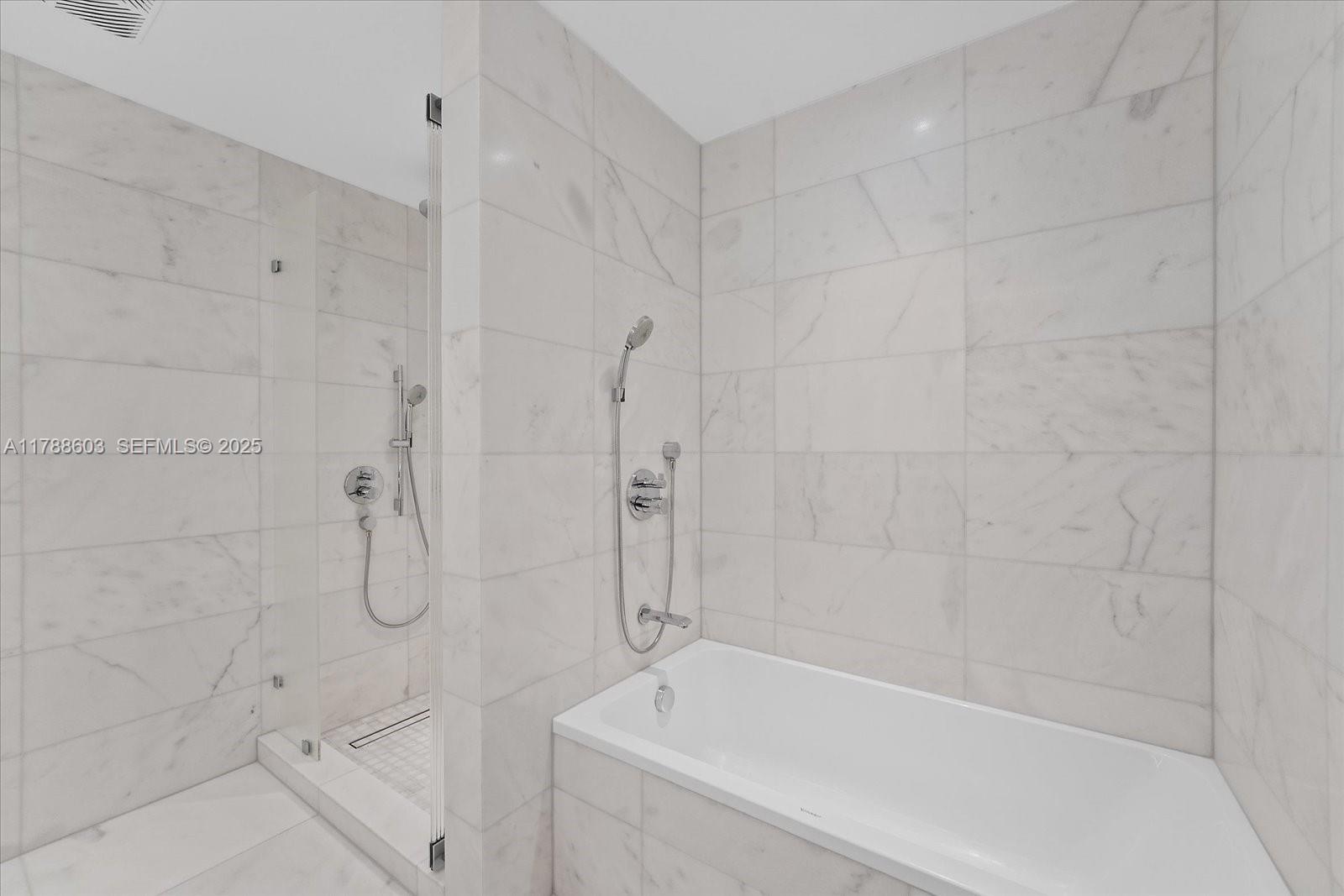 500 Alton Road, Unit 1105 Miami Beach, FL 33139 - Photo 21 of 69 a bathroom with a shower and bathtub