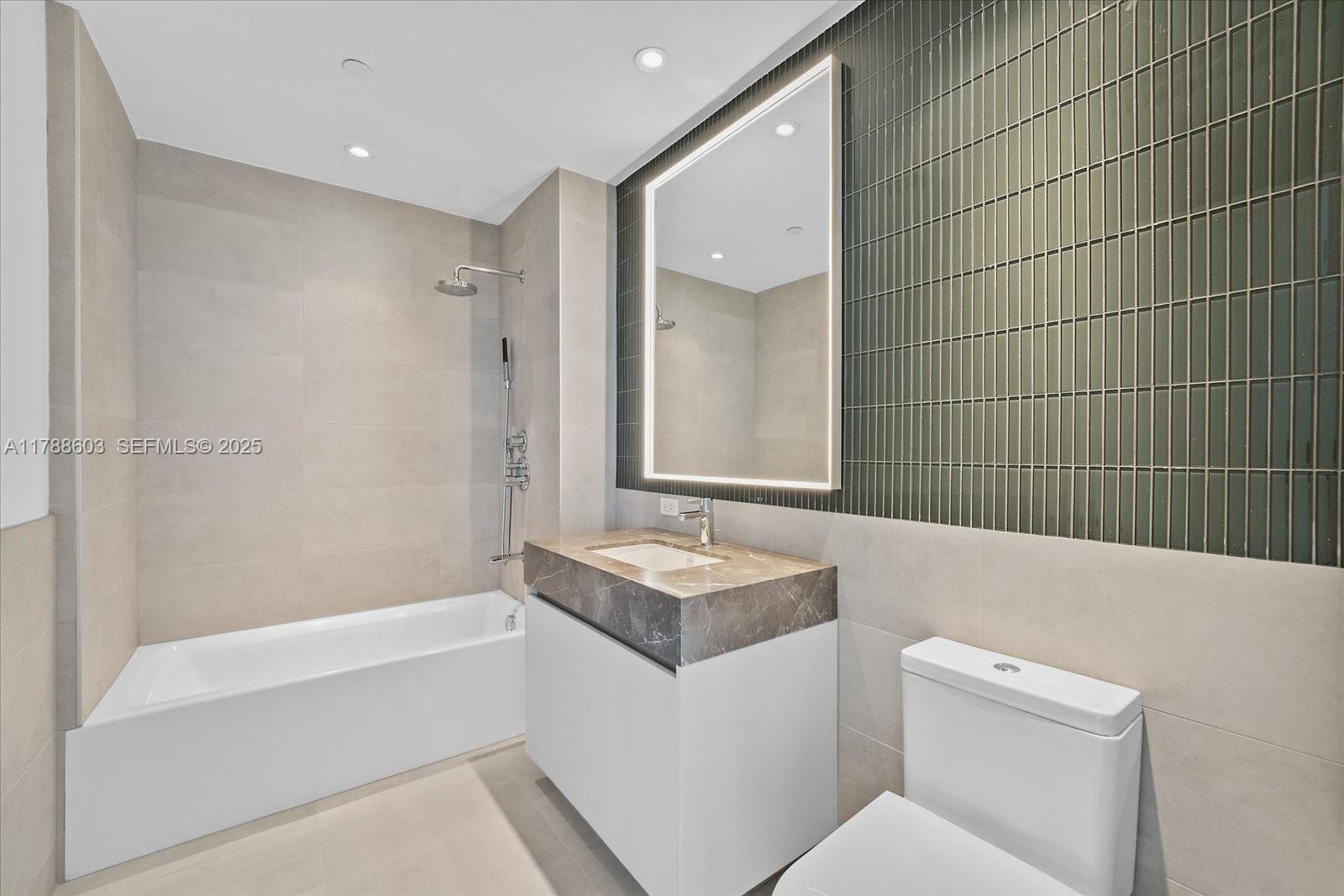 500 Alton Road, Unit 1105 Miami Beach, FL 33139 - Photo 25 of 69 a bathroom with a granite countertop sink a toilet and shower