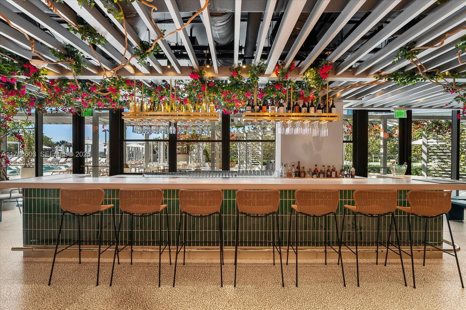 500 Alton Road, Unit 1105 Miami Beach, FL 33139 - Photo 55 of 69 a view of a chairs and table in patio with a barbeque