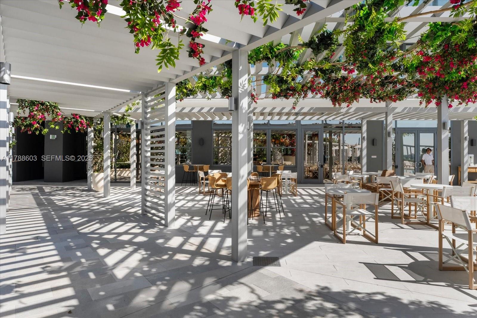 500 Alton Road, Unit 1105 Miami Beach, FL 33139 - Photo 57 of 69 a view of a patio with table and chairs and potted plants