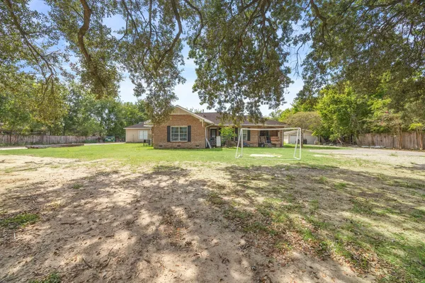 a view of a house with a yard and sitting area
