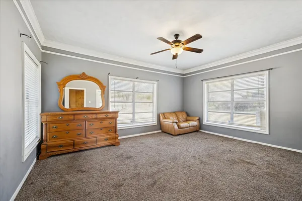 a view of a livingroom with workspace and a window
