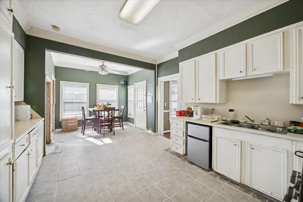 a kitchen with sink cabinets and stove top oven