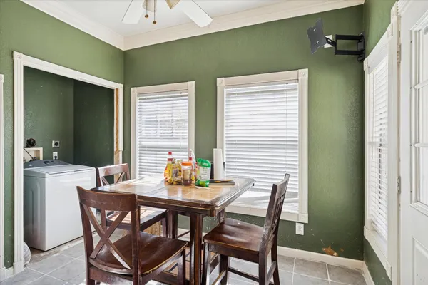 a dining room with furniture and window