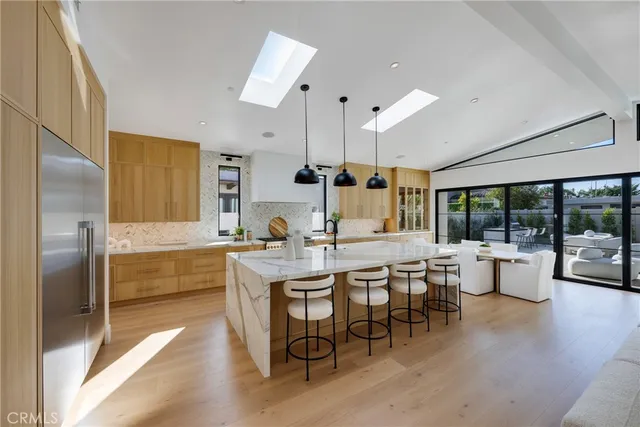a large kitchen with a table and chairs