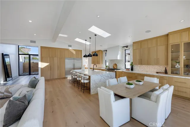 a living room with stainless steel appliances kitchen island granite countertop furniture and a kitchen view