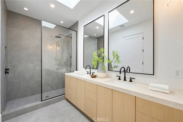 a bathroom with a granite countertop sink a toilet and shower