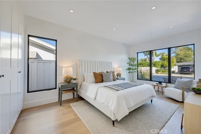 a spacious bedroom with a bed and a large window