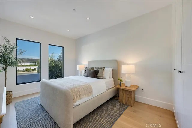 a view of a hallway with wooden floor and a large window