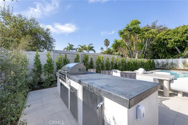 a view of a patio with a dining table and chairs with wooden floor