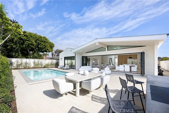 a view of swimming pool with outdoor seating and plants