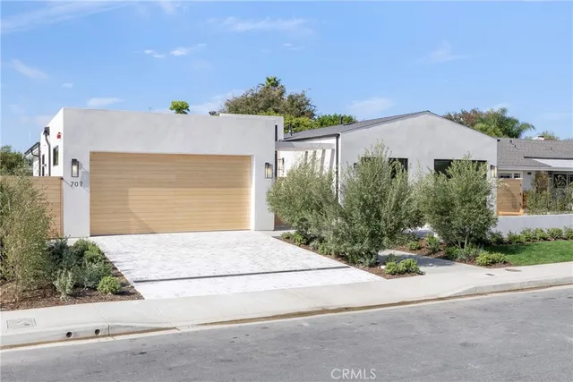 front view of a house with potted plants