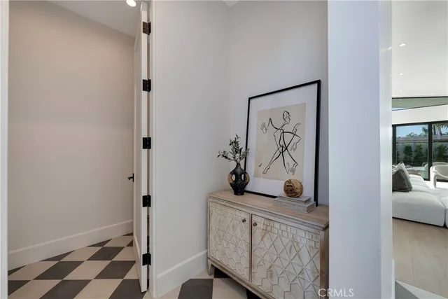 a view of a hallway to a livingroom with furniture