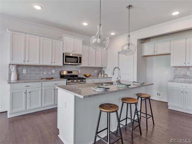 9101 Haynes Brg Road Chesterfield, VA 23832 - Photo 8 of 25 a kitchen with kitchen island granite countertop a sink a center island and cabinets