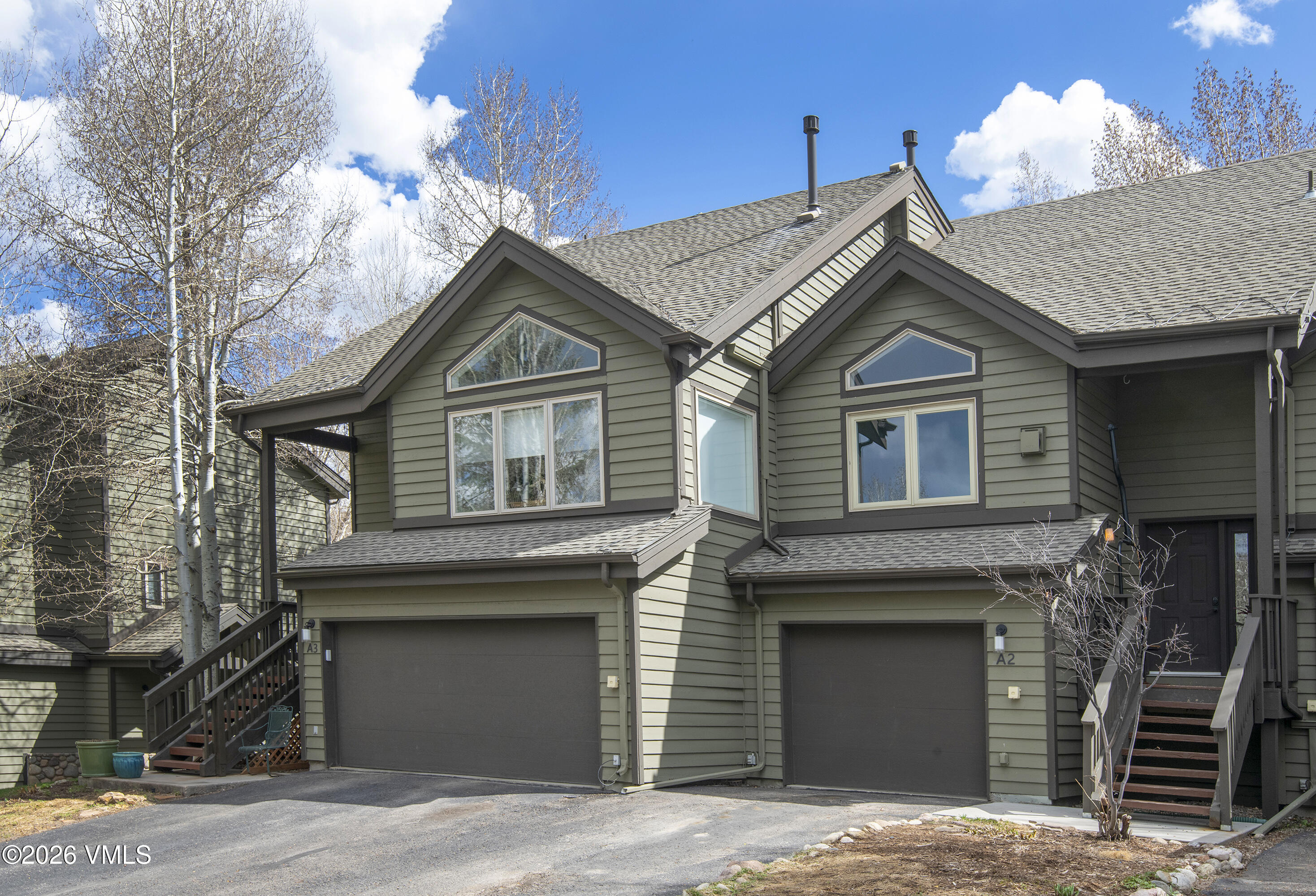 83 Arlington Place, Unit A2 Edwards, CO 81632 - Photo 18 of 19 a front view of a house with a garage and a yard