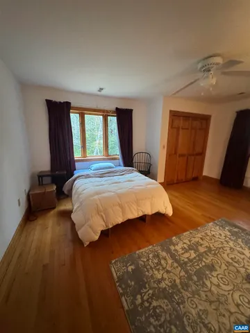 a bedroom with a bed and window