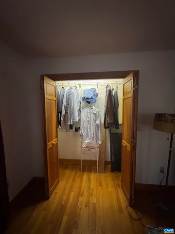 a view of a room with wooden floor and furniture