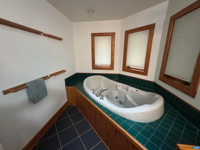a bath tub sitting in a bathroom next to a window