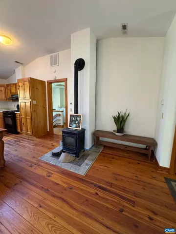 a room with wooden floor and furniture