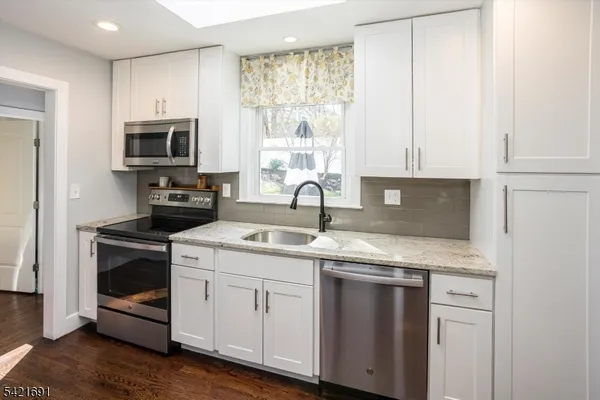 a kitchen with appliances cabinets and a sink