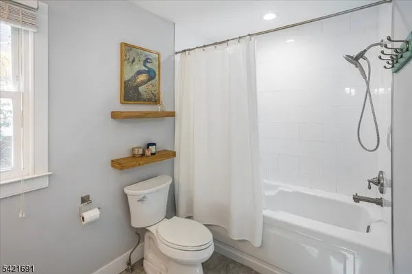 a white toilet sitting next to a bath tub shower