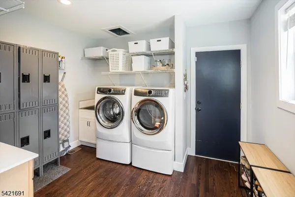 a utility room with sink dryer and washer