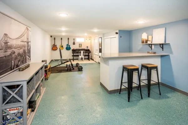 a view of a room with gym equipment and a table