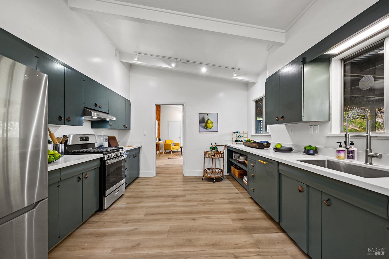 1417 Deer Lane Sebastopol, CA 95472 - Photo 13 of 66 a kitchen with stainless steel appliances a sink dishwasher a stove top oven a refrigerator with wooden floor