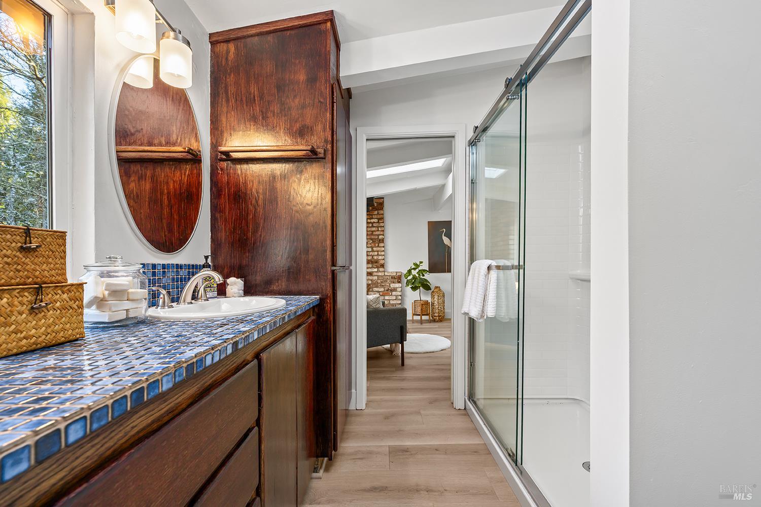 1417 Deer Lane Sebastopol, CA 95472 - Photo 28 of 66 a bathroom with a granite countertop sink a mirror and a shower