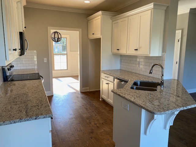 131 Flat Woods Road Lebanon, TN 37090 - Photo 9 of 25 a kitchen with stainless steel appliances granite countertop a sink stove and cabinets