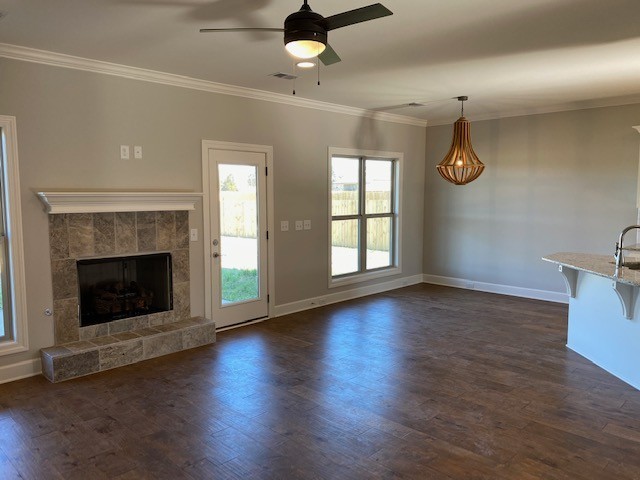 131 Flat Woods Road Lebanon, TN 37090 - Photo 10 of 25 an empty room with wooden floor a ceiling fan a fireplace and windows