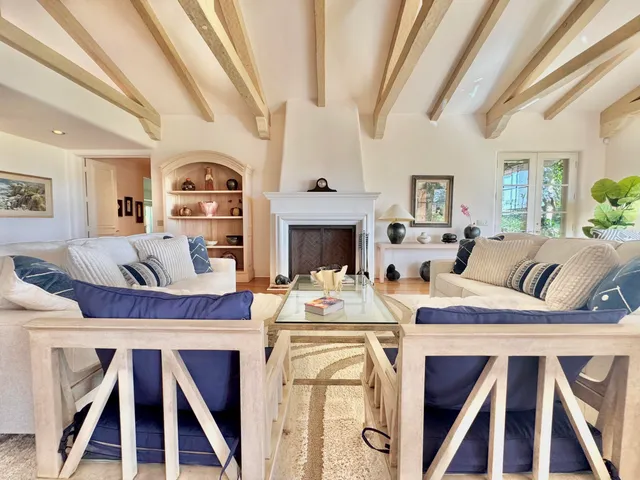 a living room with furniture and walk in closet with wooden floor